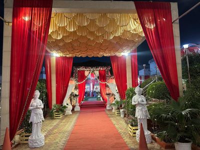 Entrance walkway with statues and gold canopy at Dharam Vatika party lawn, Sohna Gurgaon
