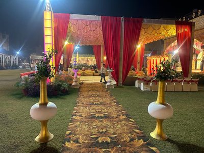 Golden carpet pathway across the lawn with gold vases, Dharam Vatika Sohna Gurgaon